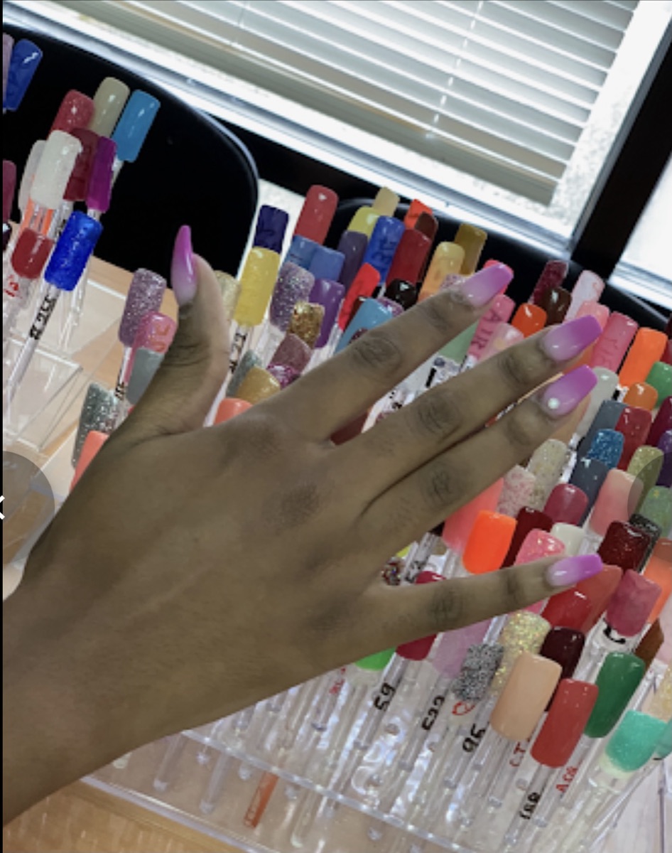 Lavender square nails over the salon's color rack