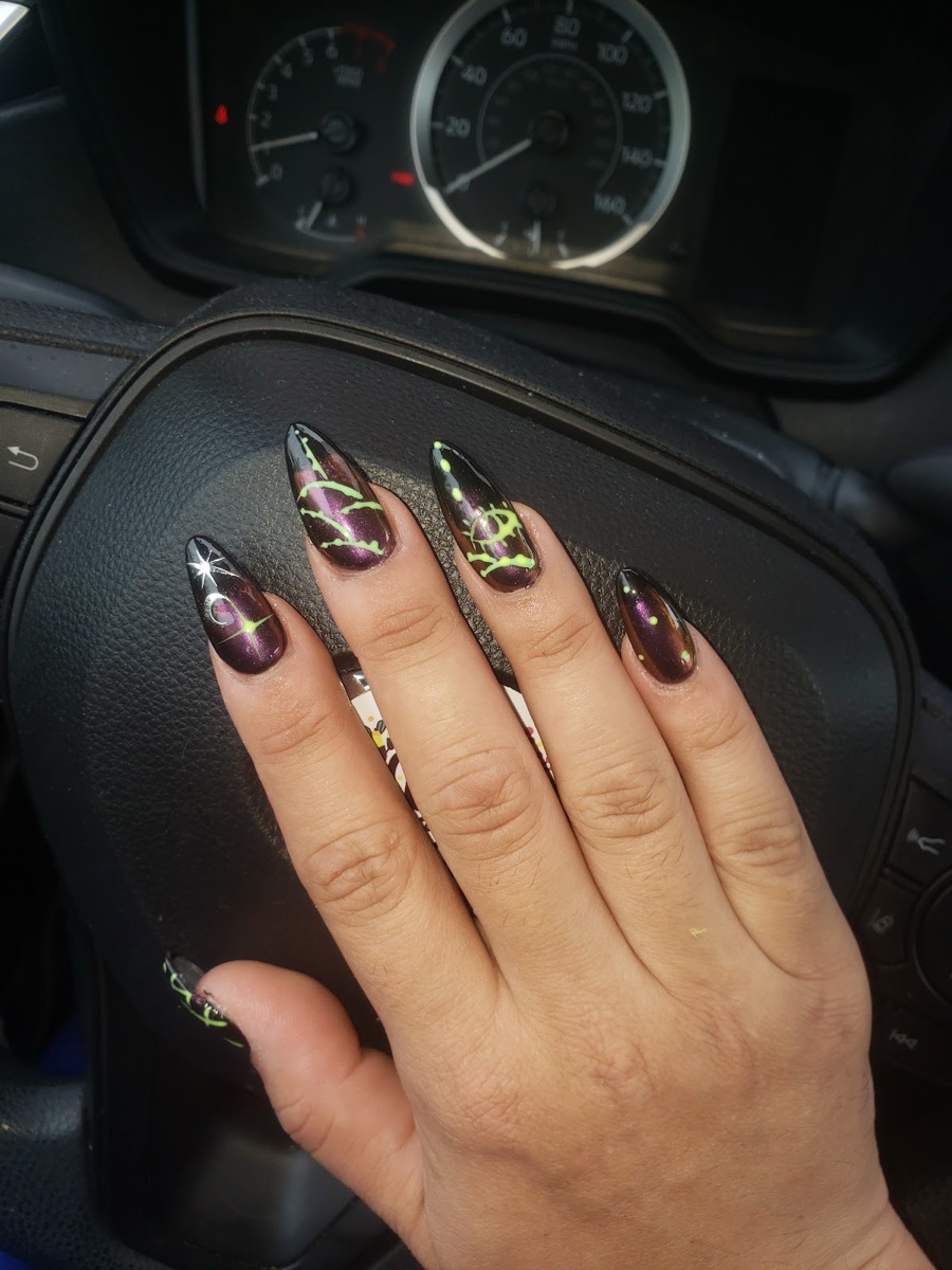 Purple chrome stiletto nails with neon green hand-painted detail