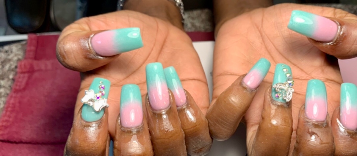 Teal-to-pink ombré coffin nails with charm accents